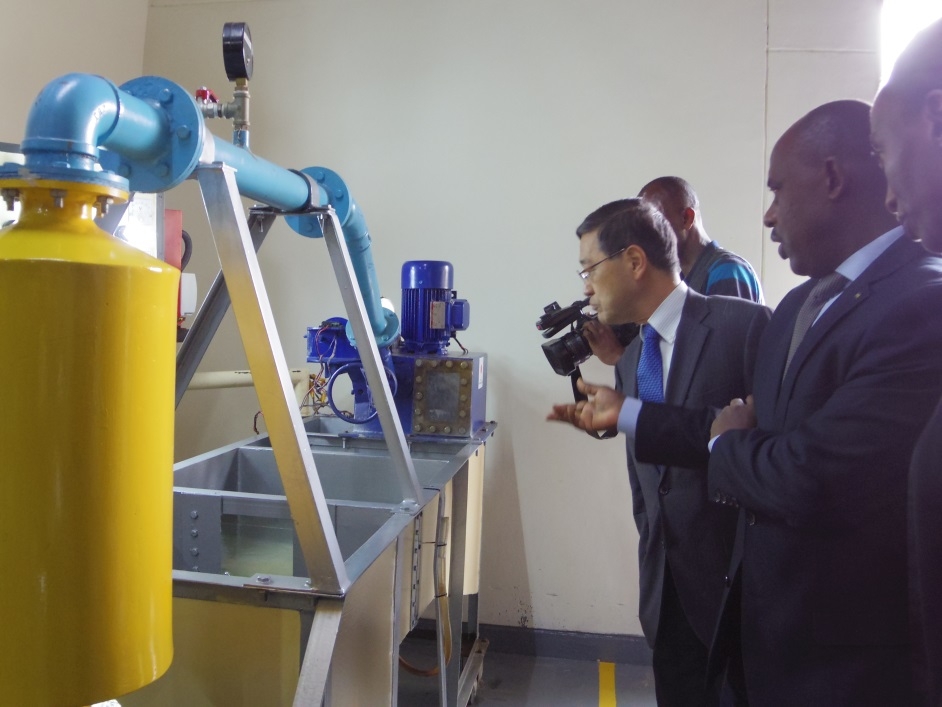 Ambassador Miyashita and Honorable Mutimura inspect equipment of the Department of Alternative Energy